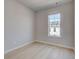 Bright bedroom features a large window and light wood-look flooring at 533 Rubato Knl, Mcdonough, GA 30253