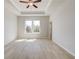 Spacious bedroom with tray ceiling, recessed lighting, and light hardwood floors at 533 Rubato Knl, Mcdonough, GA 30253
