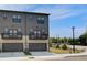 Modern townhomes feature private balconies, gray siding, and individual garages for convenient urban living at 533 Rubato Knl, Mcdonough, GA 30253