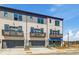 Townhome exterior featuring gray and white brick, garage, and private balconies at 533 Rubato Knl, Mcdonough, GA 30253