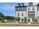 Elegant townhouse complex showcasing a mix of brick and siding, framed by lush trees and manicured landscaping at 533 Rubato Knl, Mcdonough, GA 30253