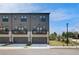 Modern townhome with neutral siding, private balconies, and attached garages at 533 Rubato Knl, Mcdonough, GA 30253