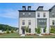 Newly built townhome with a brick facade, featuring black framed windows and freshly landscaped front yard at 533 Rubato Knl, Mcdonough, GA 30253