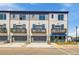 Townhome exterior featuring gray and white brick, garage, and private balconies at 533 Rubato Knl, Mcdonough, GA 30253