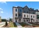Modern townhome exterior with brick facade, gray accents, and well-maintained landscaping at 533 Rubato Knl, Mcdonough, GA 30253