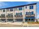 Townhome exterior featuring gray and white brick, garage, and private balconies at 533 Rubato Knl, Mcdonough, GA 30253