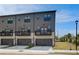 Modern townhomes with gray siding, black trim, private balconies, and garages provide stylish and convenient living at 533 Rubato Knl, Mcdonough, GA 30253