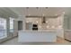 Modern kitchen featuring white cabinets, stainless steel appliances, and a spacious center island at 533 Rubato Knl, Mcdonough, GA 30253