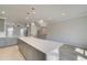 Bright kitchen with gray cabinets, white countertops, stainless steel appliances, and modern pendant lighting at 533 Rubato Knl, Mcdonough, GA 30253