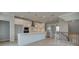 Open-concept kitchen with white cabinetry, stainless appliances, and a large island overlooking the living area at 533 Rubato Knl, Mcdonough, GA 30253