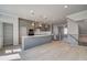 Open-concept kitchen with gray cabinets, stainless steel appliances, a large island and modern pendant lighting at 533 Rubato Knl, Mcdonough, GA 30253