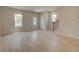 Spacious living room with light wood floors, complemented by natural light and a view of the staircase at 533 Rubato Knl, Mcdonough, GA 30253