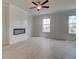Comfortable living room with a modern fireplace and plenty of natural light from the windows at 533 Rubato Knl, Mcdonough, GA 30253