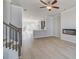 Inviting living area with staircase, modern fireplace, access to the kitchen, and sliding glass doors to the outdoor at 533 Rubato Knl, Mcdonough, GA 30253