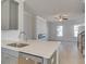 Open living room with a modern fireplace, recessed lighting, ceiling fan, and an attached kitchen area at 533 Rubato Knl, Mcdonough, GA 30253