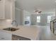 Inviting living room featuring a fireplace, ample natural light, and an open view from the kitchen at 533 Rubato Knl, Mcdonough, GA 30253