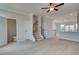 Open living room features light wood floors, a ceiling fan, and staircase access at 533 Rubato Knl, Mcdonough, GA 30253