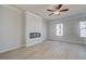 Modern living room featuring a sleek electric fireplace and neutral paint, illuminated by recessed lighting and natural light at 533 Rubato Knl, Mcdonough, GA 30253