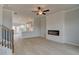 Open-concept living room with fireplace flowing into kitchen with white cabinets at 533 Rubato Knl, Mcdonough, GA 30253