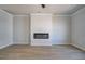 Spacious living room with modern electric fireplace, ceiling fan, and neutral paint providing a cozy and inviting space at 533 Rubato Knl, Mcdonough, GA 30253