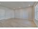 Bright living room features hardwood floors, recessed lighting, and a window for natural light at 533 Rubato Knl, Mcdonough, GA 30253