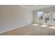 Bright living room with hardwood floors, neutral walls, and access to a private balcony at 533 Rubato Knl, Mcdonough, GA 30253