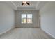 Spacious main bedroom with tray ceiling and large windows for plenty of natural light at 533 Rubato Knl, Mcdonough, GA 30253