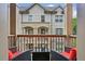 Cozy balcony with outdoor seating, a view of a white brick building, and a relaxed atmosphere at 600 Luckett Ct, Smyrna, GA 30080