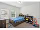 Cozy bedroom with a wood bed frame, blue patterned cover, and lots of natural light from two windows at 600 Luckett Ct, Smyrna, GA 30080