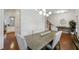 Bright dining room features a wood table, six chairs, chandelier, wood floors, and flows into the kitchen at 600 Luckett Ct, Smyrna, GA 30080