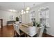 Dining room with hardwood floors, stylish lighting, a table with six chairs, and natural light from the windows at 600 Luckett Ct, Smyrna, GA 30080