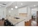 Island kitchen with granite countertops, stylish pendant lighting, and stainless steel appliances at 600 Luckett Ct, Smyrna, GA 30080