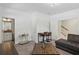 Inviting living room featuring a gray couch, a table with chairs, and a gold bar cart at 600 Luckett Ct, Smyrna, GA 30080