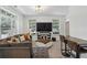 Inviting living room with large windows, a comfy gray couch, and a large flat screen television at 600 Luckett Ct, Smyrna, GA 30080