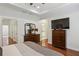 Spacious main bedroom features a tray ceiling, hardwood floors, and a large dresser with a mirror at 600 Luckett Ct, Smyrna, GA 30080