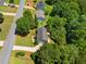 Overhead view of a residential property with a tree-lined street, surrounded by lush greenery at 90 Cypress Dr, Covington, GA 30016