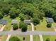 An aerial view of a neighborhood with tree-lined streets and green lawns surrounding each home at 90 Cypress Dr, Covington, GA 30016