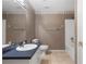 Bathroom featuring a single sink vanity with dark blue counter, toilet and tiled floor at 90 Cypress Dr, Covington, GA 30016