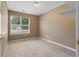 Neutral-toned bedroom with window offering natural light and gold door knob at 90 Cypress Dr, Covington, GA 30016