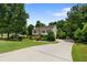 Inviting home with lush green lawn, mature trees, and extended driveway at 90 Cypress Dr, Covington, GA 30016