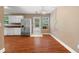 Kitchen area with stainless steel refrigerator, white cabinets and access to the rear patio at 90 Cypress Dr, Covington, GA 30016