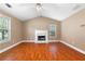 Bright living room with hardwood floors, vaulted ceilings, and a cozy fireplace at 90 Cypress Dr, Covington, GA 30016