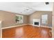 Spacious living room featuring hardwood floors, a fireplace, and plenty of natural light at 90 Cypress Dr, Covington, GA 30016