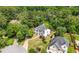 High aerial of home with gray roof in a wooded neighborhood on a cul-de-sac at 9206 Denmeade Trce, Douglasville, GA 30135