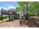 Back exterior with wooden staircase leading to a deck with lattice railing at 9206 Denmeade Trce, Douglasville, GA 30135