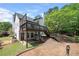 View of home's tiered deck leading down to a walkout patio and grassy yard at 9206 Denmeade Trce, Douglasville, GA 30135