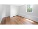 Neutral bedroom featuring hardwood floors, closet, and natural light from the window at 9206 Denmeade Trce, Douglasville, GA 30135