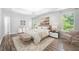 Stylishly furnished bedroom with tray ceilings, vinyl floors, and natural light at 9206 Denmeade Trce, Douglasville, GA 30135