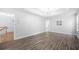 Bedroom with tray ceilings, vinyl floors, and view into bathroom at 9206 Denmeade Trce, Douglasville, GA 30135