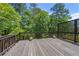 Wooden deck surrounded by lush trees at 9206 Denmeade Trce, Douglasville, GA 30135